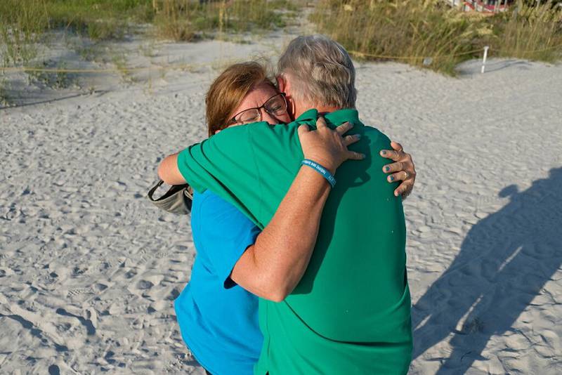 Volunteers got down onto the sand to clean up the beaches, but Dan Durbec also got down on one knee for his now-fiancé Deb.