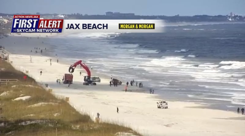 Heavy machinery has been brought in to remove a broken-down sailboat from Jacksonville Beach.