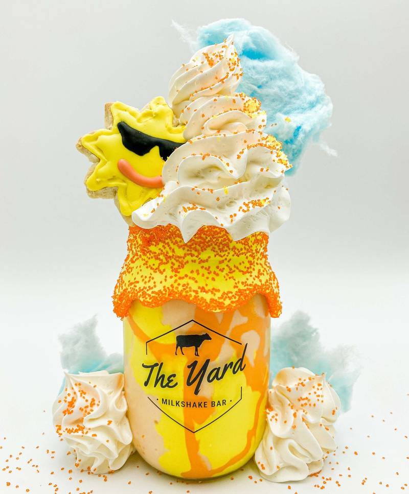 Jacksonville's exclusive signature shake is The Sunshine Shake, made with Orange Blossom ice cream with yellow and orange marshmallow drizzle in a yellow marshmallow dipped jar rolled in orange sugar sprinkles. Topped with whipped cream, a locally sourced sunshine cookie, a cotton candy cloud and more sugar sprinkles.