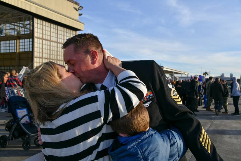 Long overdue kiss after coming home.