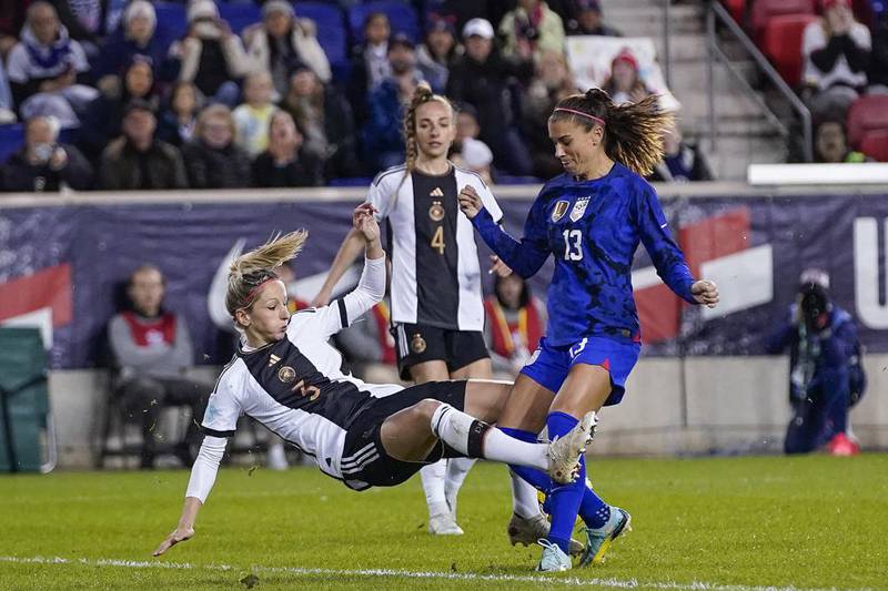United States forward Alex Morgan (13) and Germany defender Kathrin Hendrich (3) fight for the ball during a women's international friendly soccer match Sunday, Nov. 13, 2022, in Harrison, N.J.