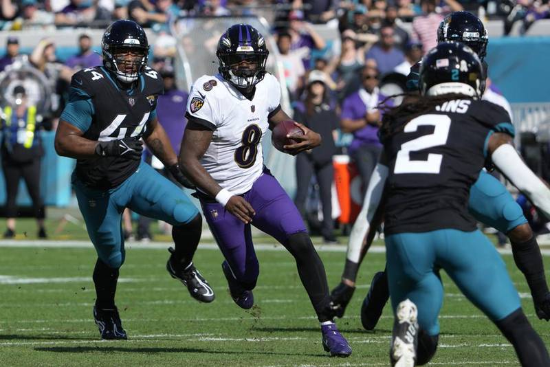 Baltimore Ravens quarterback Lamar Jackson (8) runs the ball during the first half of an NFL football game against the Jacksonville Jaguars, Sunday, Nov. 27, 2022, in Jacksonville, Fla.