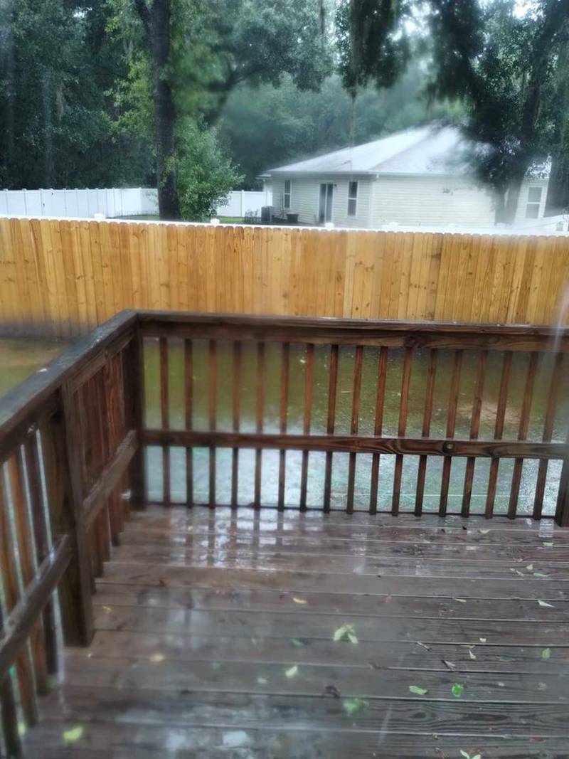 Flooding seen from a deck in a Mcclenny backyard.