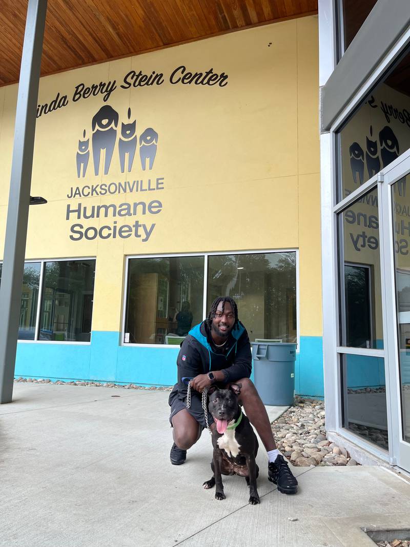 Jags' Devin Lloyd poses with new member of his family, Lilith after adopting her from Jacksonville Humane Society.