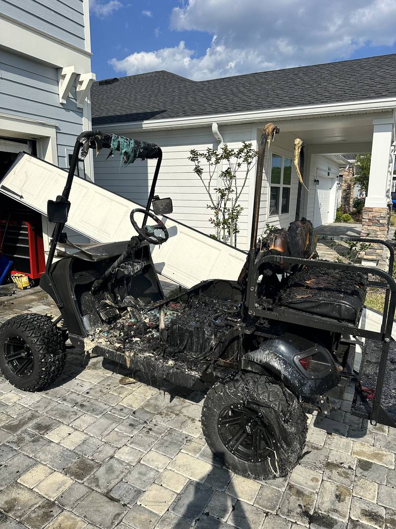 The initial cause of the fire was determined to be a charging golf cart in the garage area.