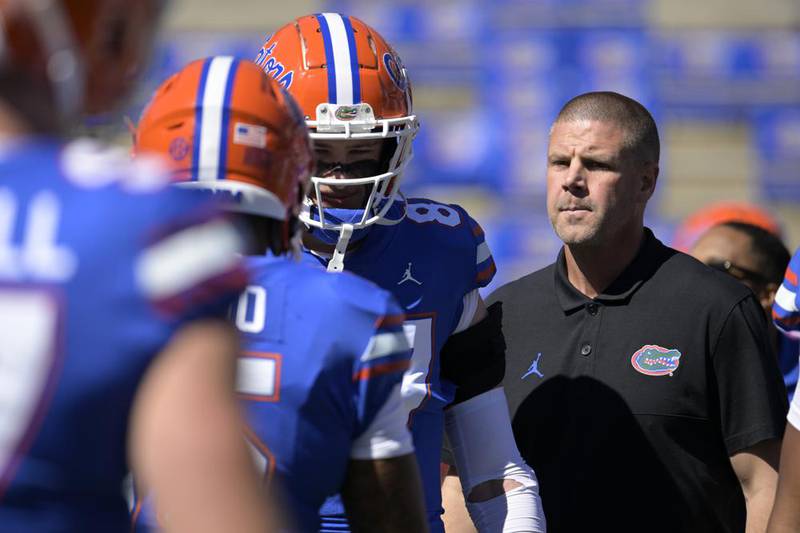 Florida head coach Billy Napier, right, watches players warm up before an NCAA college football game against Eastern Washington, Sunday, Oct. 2, 2022, in Gainesville, Fla. A person familiar with the situation says Florida quarterback recruit Jaden Rashada requested a release from his national letter of intent Tuesday, Jan. 17, 2023 after a $13 million name, imagine and likeness deal fell through.