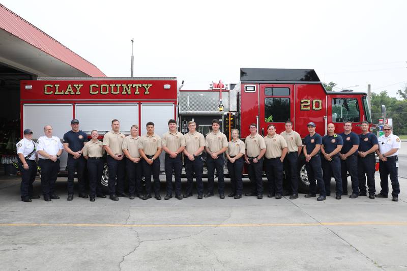 Non-certified recruits and members of Station 20 pose in front of Engine 20 before the "Push-In" ceremony.