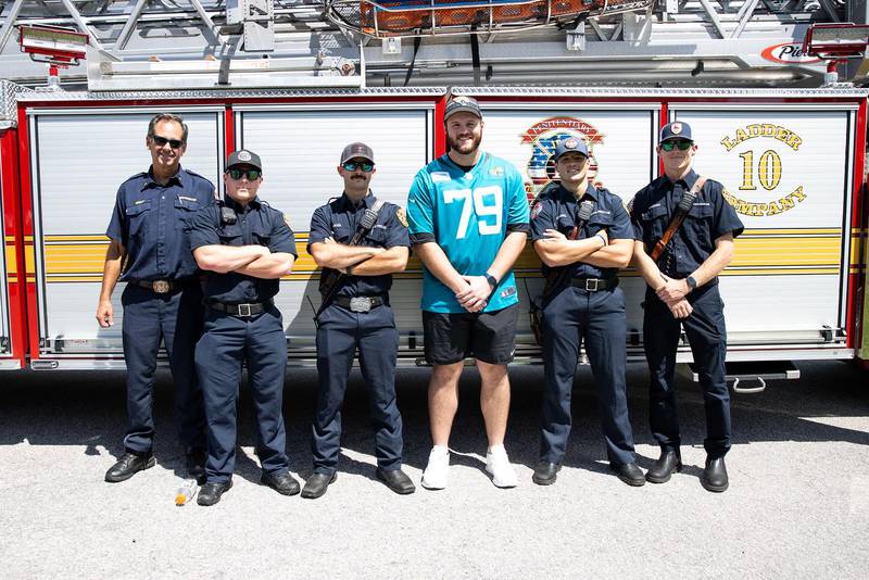 Jags' Luke Fortner standing with his brothers and sisters of the Jacksonville Fire Rescue Department.