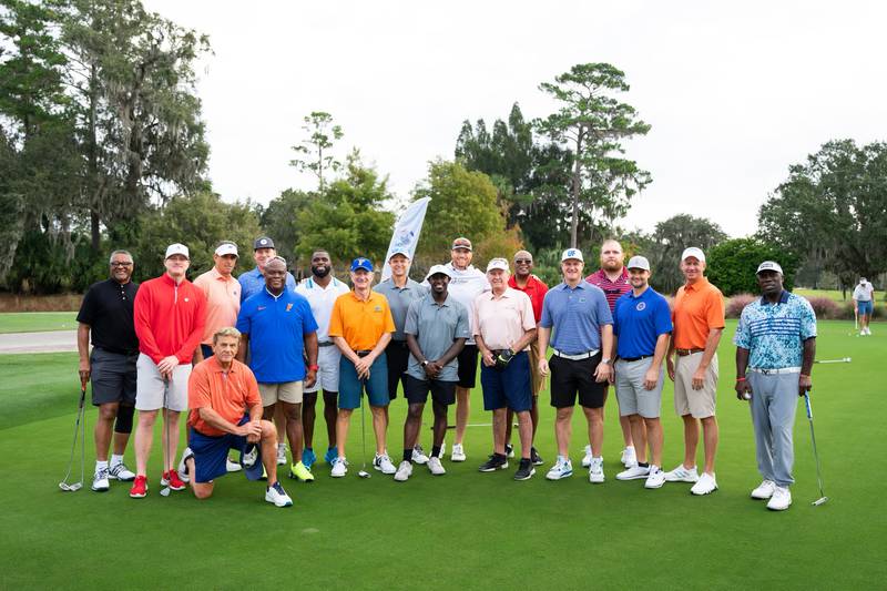 Group shot featuring Danny Wuerffel, Coach Steve Spurrier, UF and UGA alums.