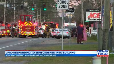 Photos: 5 injured after sand truck crashes into building on Jacksonville's Westside
