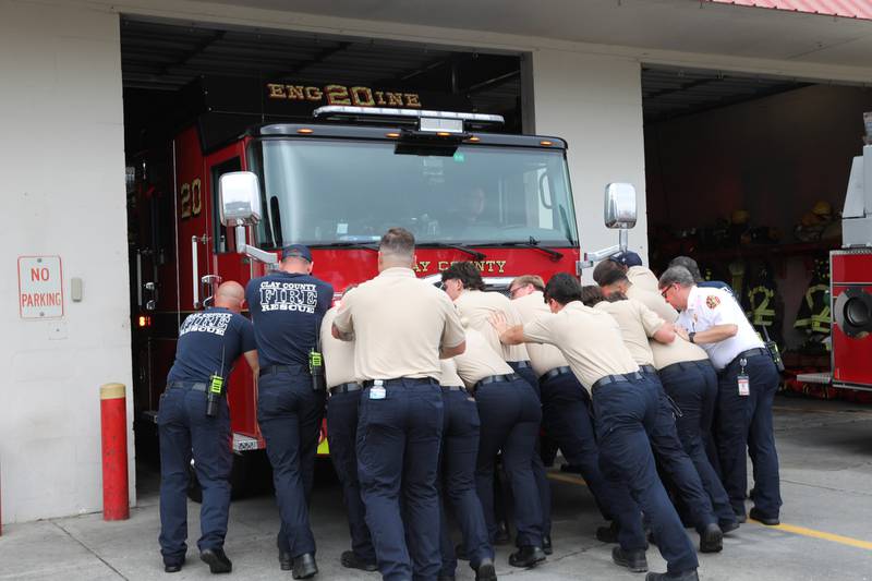 Crew members and non-certified recruits join in on the "push-in" ceremony for Engine 20.