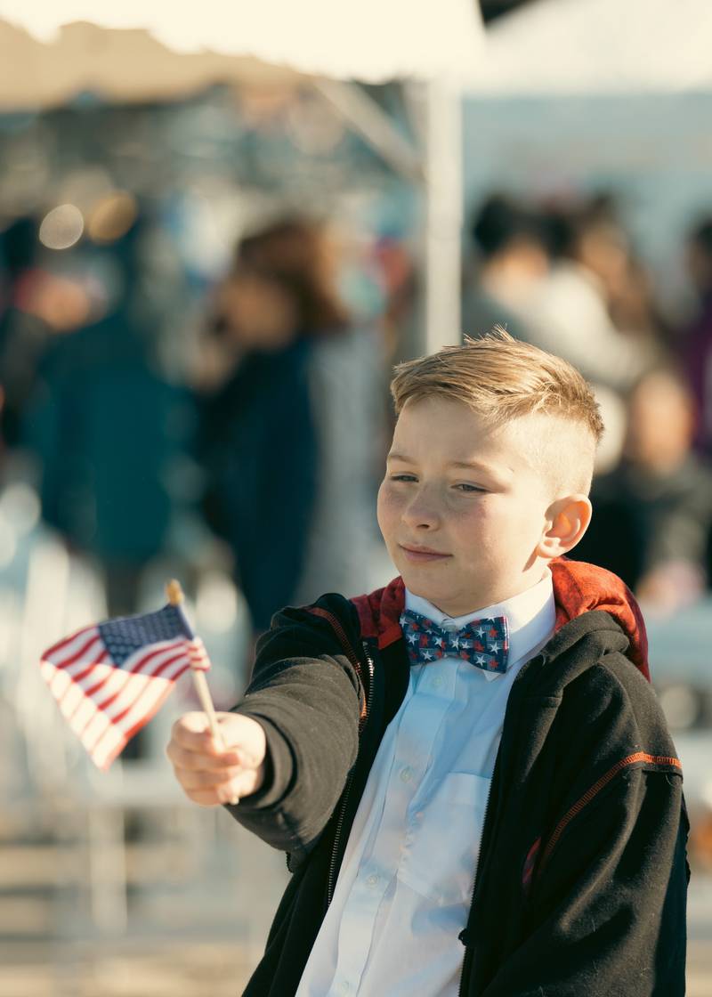 This young man celebrates the return home of USS Thomas Hudner.