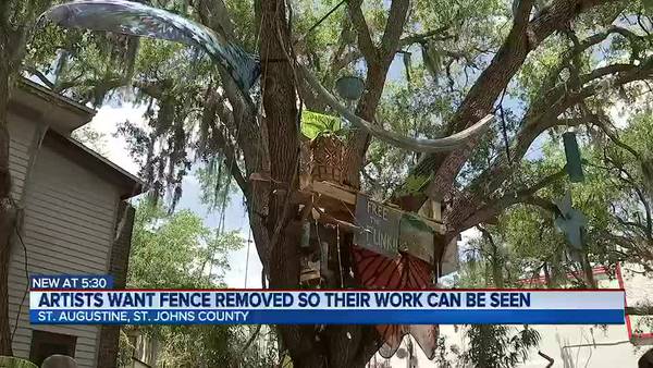 Artists want fence removed so their work can be seen