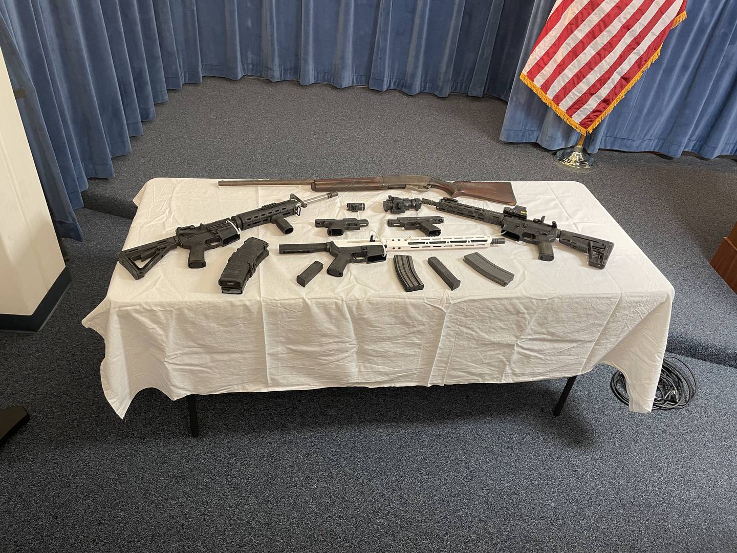 Guns on table at news conference announcing arrest for incident that happened on Duval school board property.