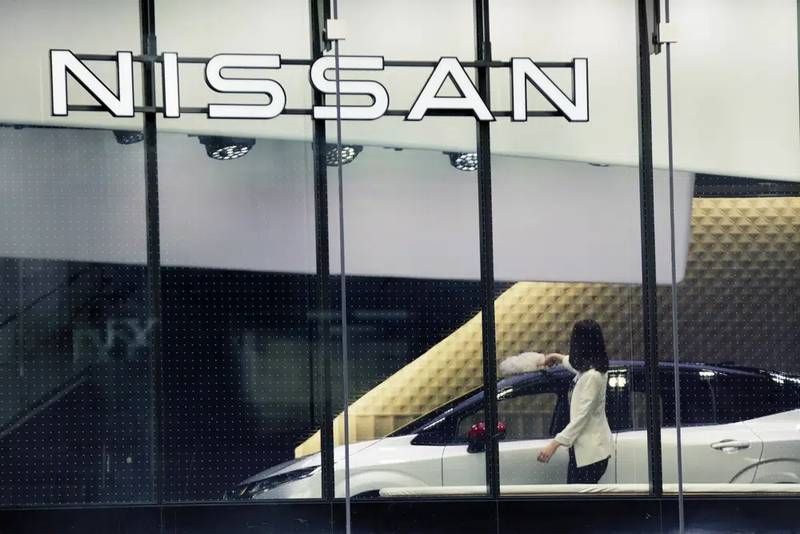 A staff of Nissan car showroom wipes a car on Jan. 31, 2022, in Tokyo. Nissan reported a 55% jump in October-December profit Thursday, Feb. 9, 2023, as the Japanese automaker seeks to embark on a less bumpy journey with its French alliance partner Renault.