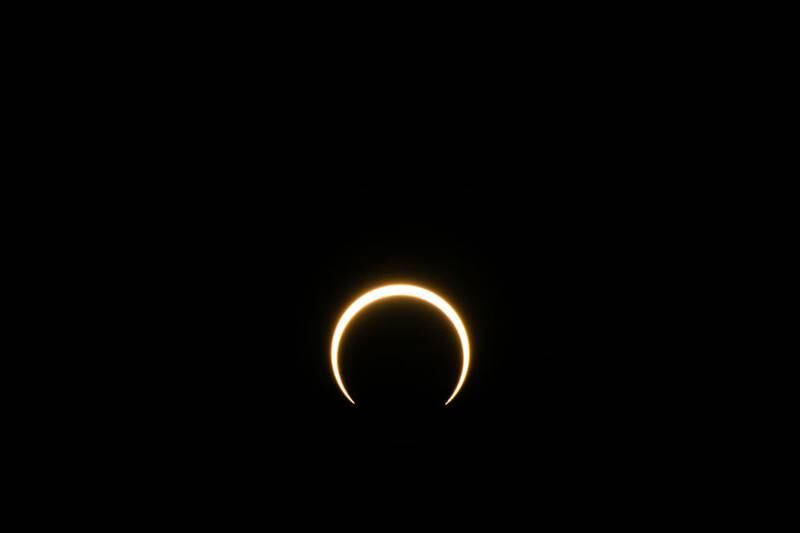KERRVILLE, TEXAS - OCTOBER 14: The moon begins to fall below the sun's horizon during an annular solar eclipse on October 14, 2023 in Kerrville, Texas. Differing from a total solar eclipse, the moon in an annular solar eclipse covers part of the sun's light, creating the "ring of fire" effect around the moon. (Photo by Brandon Bell/Getty Images)
