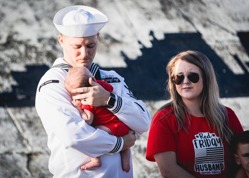 Families say their goodbyes before sailors embark on a regularly planned deployment of USS Mason.