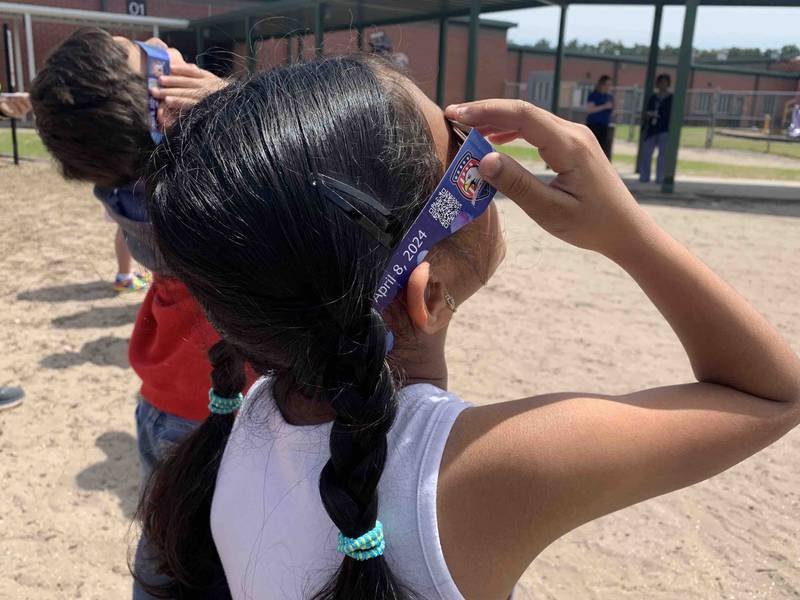 Students at Bartram Springs Elementary School take in the view of the 2024 solar eclipse.