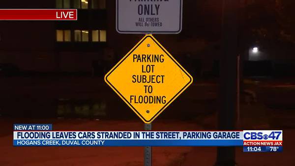 Flooding leaves cars stranded in the street, parking garage