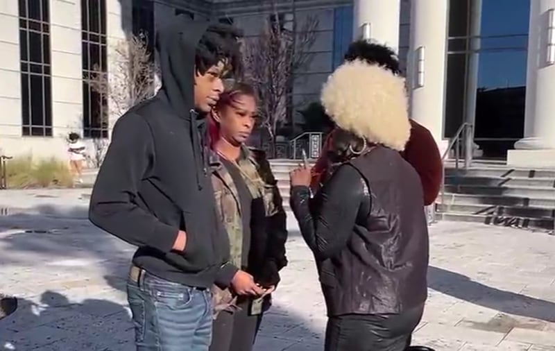 Le'Keian Woods (left) stands outside the Duval County Courthouse in January.