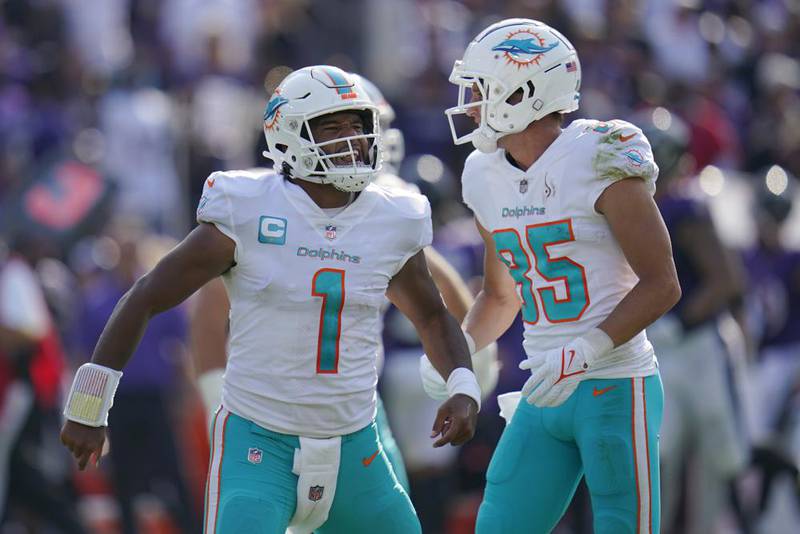 Miami Dolphins quarterback Tua Tagovailoa (1) and wide receiver River Cracraft (85) celebrate a touchdown during the second half of an NFL football game against the Baltimore Ravens, Sunday, Sept. 18, 2022, in Baltimore.