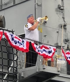 Bugler aboard USS Orleck honoring fallen soldiers of the Korean War.