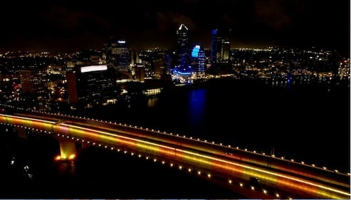 The Acosta Bridge was lit up Tuesday night in gold and orange to shine a light on pediatric cancer. “Team Joe Strong” rode bicycles across the bridge in memory of Joe Dewaele.