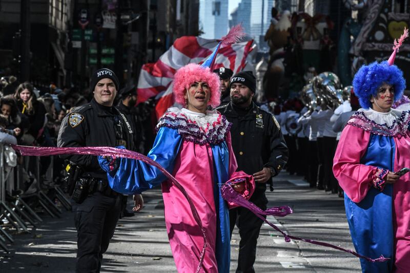 NEW YORK, NEW YORK - NOVEMBER 23: People participate in Macy's annual Thanksgiving Day Parade on November 23, 2023 in New York City. Thousands of people lined the streets to watch the 25 balloons and hundreds of performers march in this parade happening since 1924. (Photo by Stephanie Keith/Getty Images)