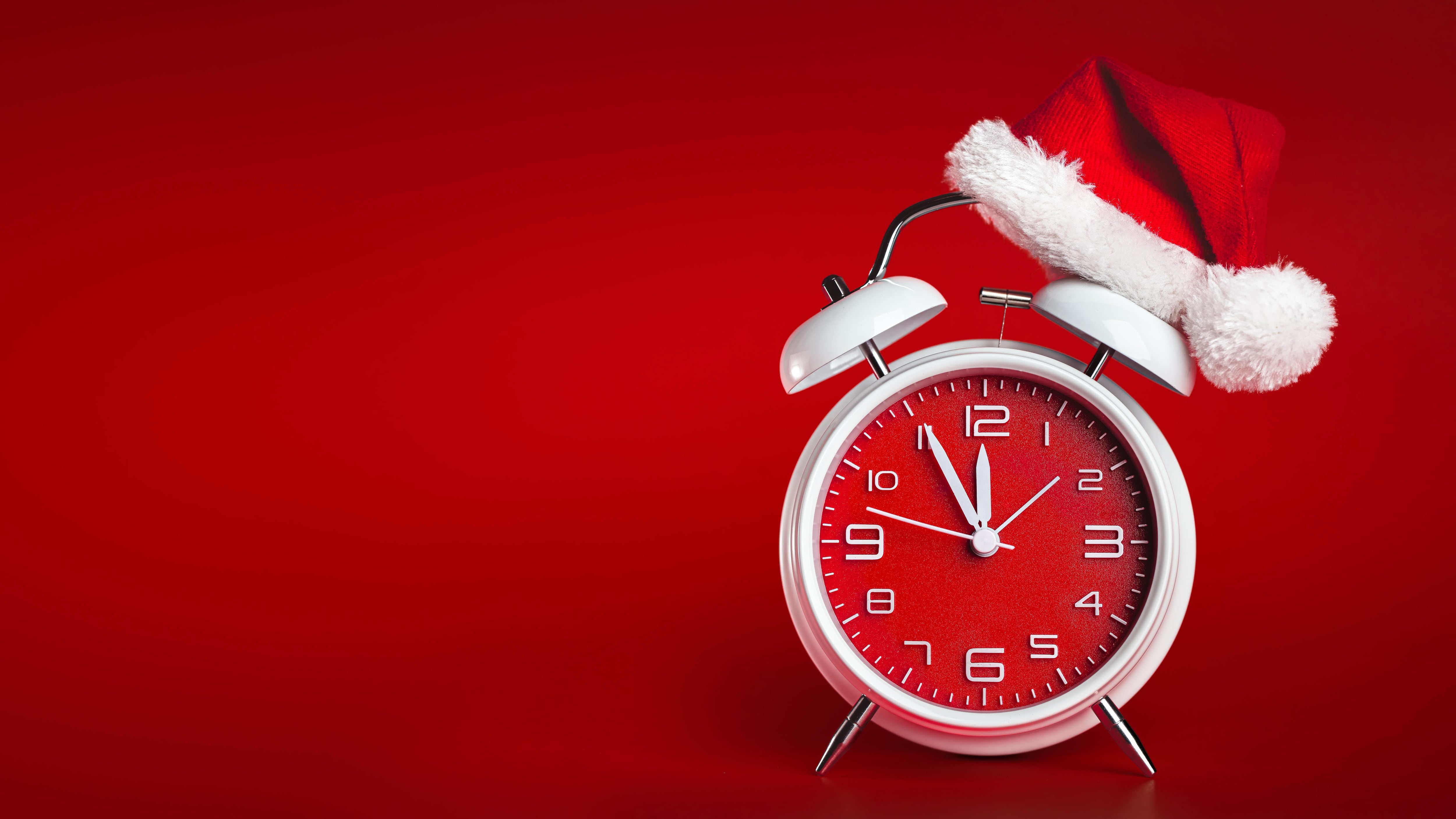 Red clock with Christmas Santa hat.