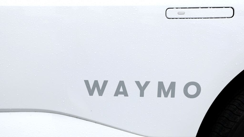 Waymo logo on the side of a car