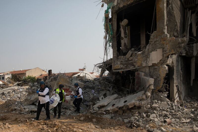 SDEROT, ISRAEL - OCTOBER 08:  Israeli rescue members work at a police station that was destroyed after a battle between Israeli troops and Hamas militants on October 8, 2023 in Sderot, Israel. On Saturday, the Palestinian militant group Hamas launched the largest surprise attack from Gaza in a generation, sending thousands of missiles and an unknown number of fighters by land, who shot and kidnapped Israelis in communities near the Gaza border. The attack prompted retaliatory strikes on Gaza and a declaration of war by the Israeli prime minister.  (Photo by Amir Levy/Getty Images)