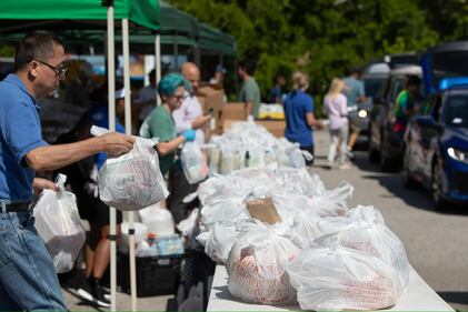 Many volunteers including Mayor Deegan assisted in distributing food to military members and their families on Thursday.