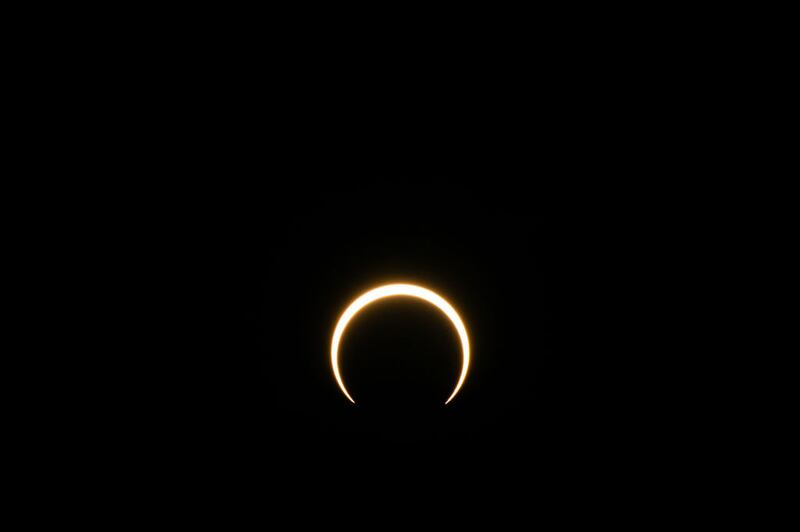 KERRVILLE, TEXAS - OCTOBER 14: The moon begins to fall below the sun's horizon during an annular solar eclipse on October 14, 2023 in Kerrville, Texas. Differing from a total solar eclipse, the moon in an annular solar eclipse covers part of the sun's light, creating the "ring of fire" effect around the moon. (Photo by Brandon Bell/Getty Images)
