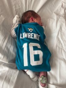 Babies from various local Baptist Health hospitals wearing Trevor Lawrence jersey onesies