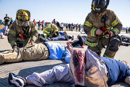 Volunteers put on fake blood and other make-up to simulate injuries.