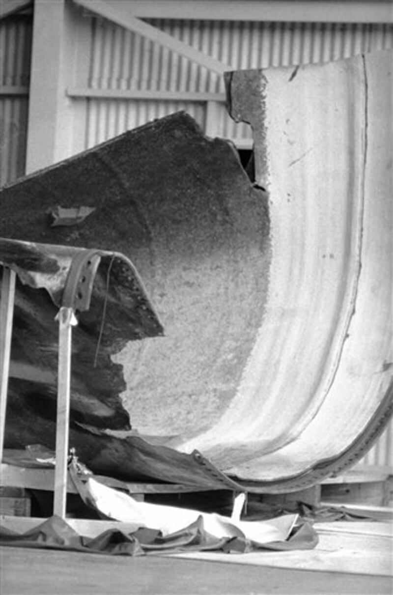 The front landing gear of the Space Shuttle Challenger as well as other structural components can be seen in this photograph taken in the storage area of the Kennedy Space Centers logistics building on June 12, 1986. NASA has recovered 35 percent of the shuttle, 50 percent of the solid rocket boosters and 15 percent of the external fuel tank. A NASA poster of the Shuttle is visible in the background of this photo. (AP Photo/James Neihouse)