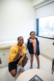 A young fan, posing with Travis Etienne, and her family moved to Jacksonville from Seattle and was told by dad, "we need to root for the home team."