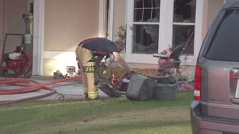 Fire fighter surveys damage to possessions.