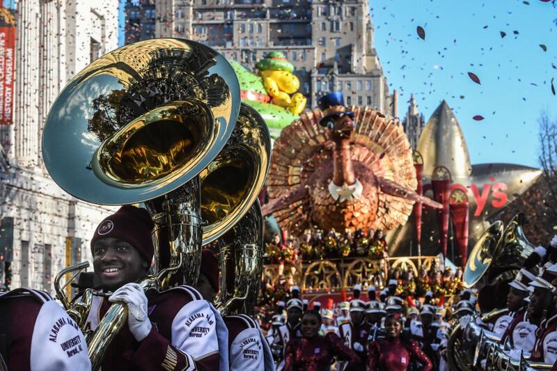 NEW YORK, NEW YORK - NOVEMBER 23: People participate in Macy's annual Thanksgiving Day Parade on November 23, 2023 in New York City. Thousands of people lined the streets to watch the 25 balloons and hundreds of performers march in this parade happening since 1924. (Photo by Stephanie Keith/Getty Images)