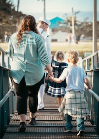 A family holds hands before their loved one gets ready to depart on board the USS Mason.