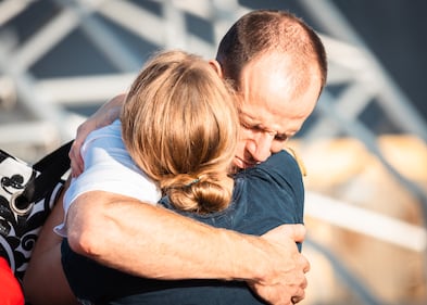 Loved ones share a moment of hugs before leaving Naval Station Mayport on planned deployment.