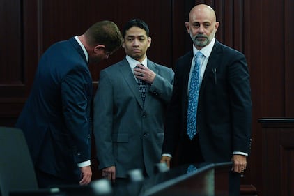 Defense attorney Jesse Dreicer, left, checks his defendant’s suit as Mario Fernandez Saldana, center, fixes his tie  before the start of jury selection in his murder trial Monday morning, August 10, 2026 in the Duval County Courthouse in Jacksonville, Fla. as his co-defense attorney James Hill, right, waits. [Doug Engle/Florida Times-Union]