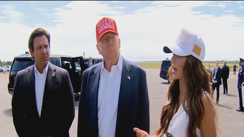 DHS Secretary Kristi Noem speaks after arriving at Alligator Alcatraz as Florida Gov. Ron DeSantis (left) and President Donald Trump look on.