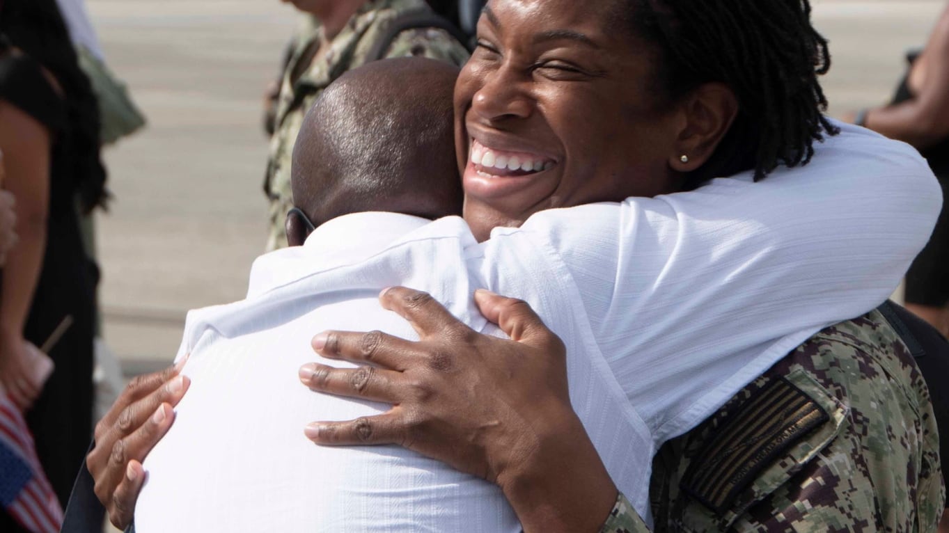JACKSONVILLE, Fla. (Oct. 8, 2023) Logistics Specialist Chief Ayisha Ross embraces a loved one. Patrol Squadron Sixteen (VP) 16, returns home after a six month deployment to 7th Fleet. (U.S. Navy photo by: Mass Communication Specialist Second Class (NAC/AW) Mathew Lombardo)