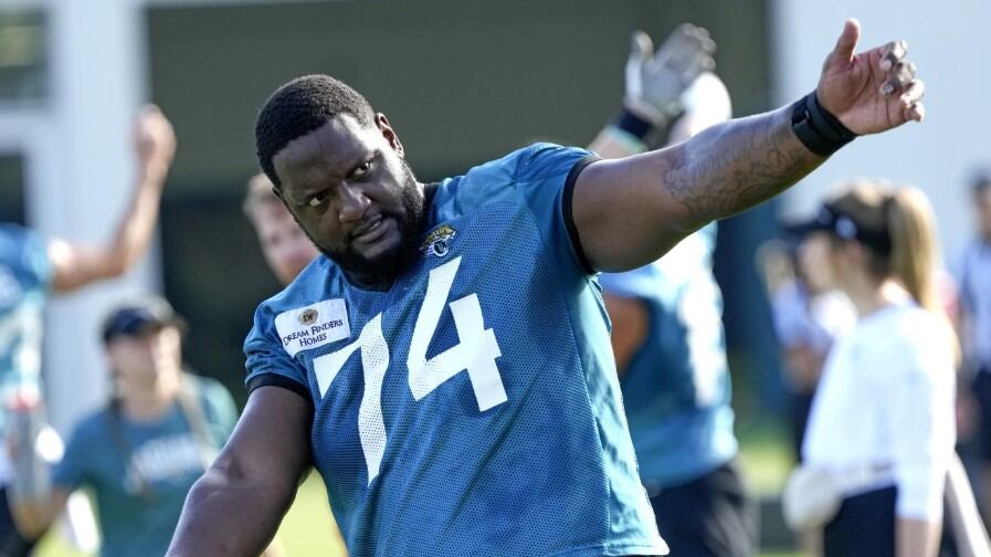Cam Robinson warms up at a training camp practice on Thursday, July 27, 2023.