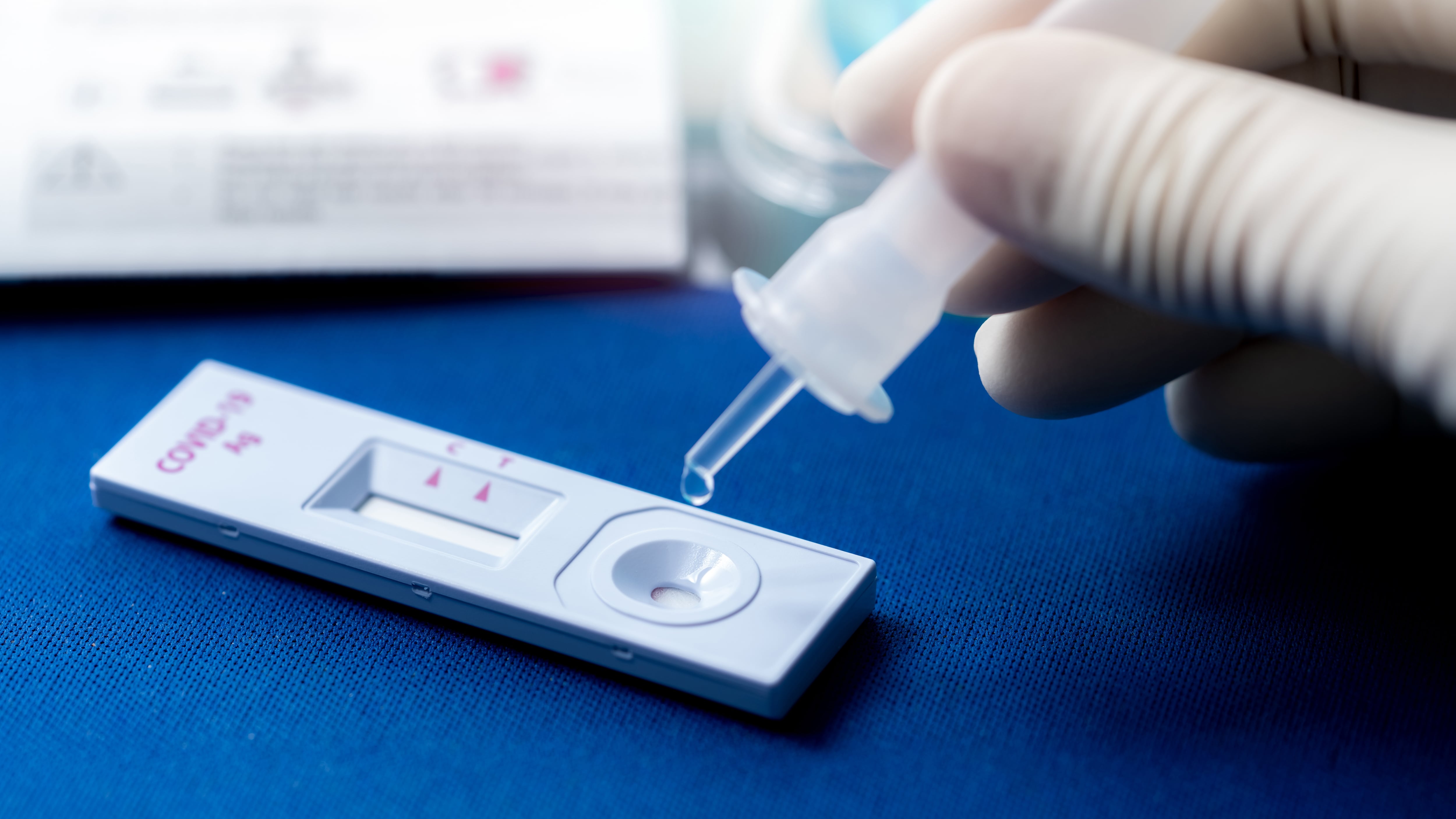 Hand holding sample tube and drops in the test device of covid 19 antigen self test. Antigen test kit for detection of coronavirus infection. Rapid antigen test. Coronavirus diagnosis. Medical device.