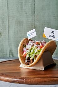 Classic Greek Gyro: Lamb and beef gyro meat served in a warm pita, topped with lettuce, tomato, red onion and tzatziki sauce. Available at MedEx (upper level).