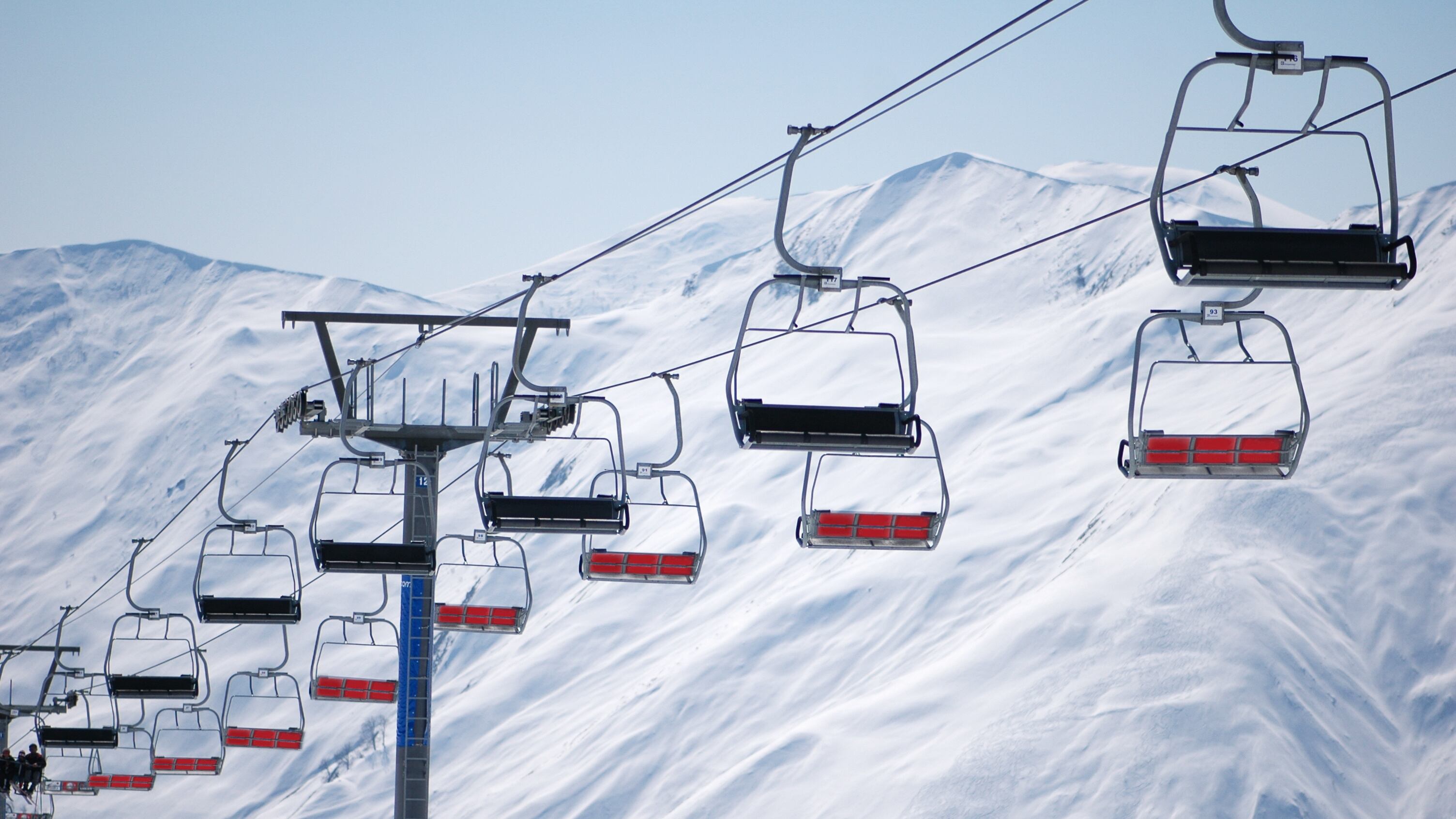 Ski lift chairs on bright winter day