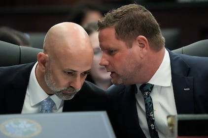 Defense Attorneys James Hill, left and Jesse Dreicer, right, whisper during jury selection in their client’s murder trial Monday morning, August 10, 2026 in the Duval County Courthouse in Jacksonville, Fla. [Doug Engle/Florida Times-Union]
