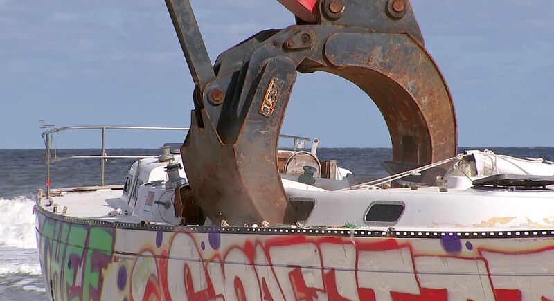 Crews came Tuesday to remove a sailboat that washed ashore on Jacksonville Beach in October.